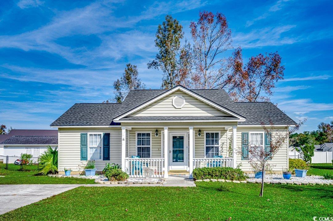 Bungalow with a porch and a front lawn