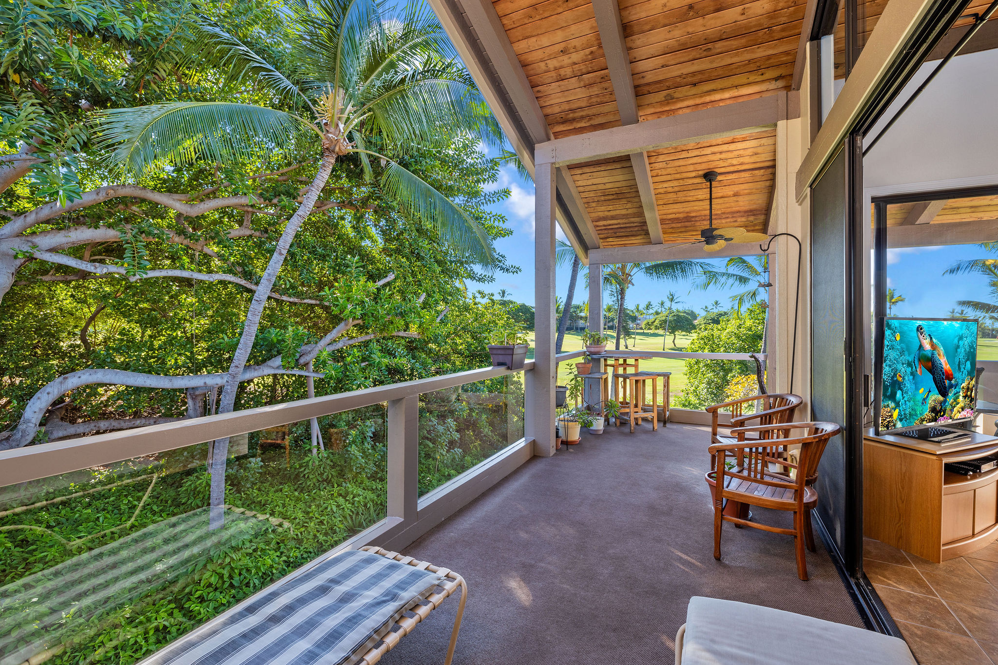 a balcony with furniture and garden view