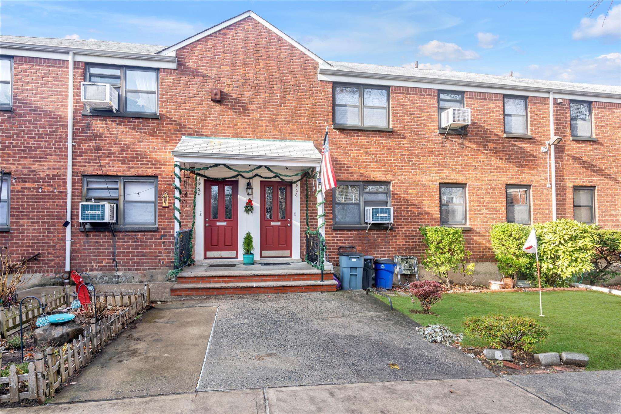 front view of a brick house with a yard