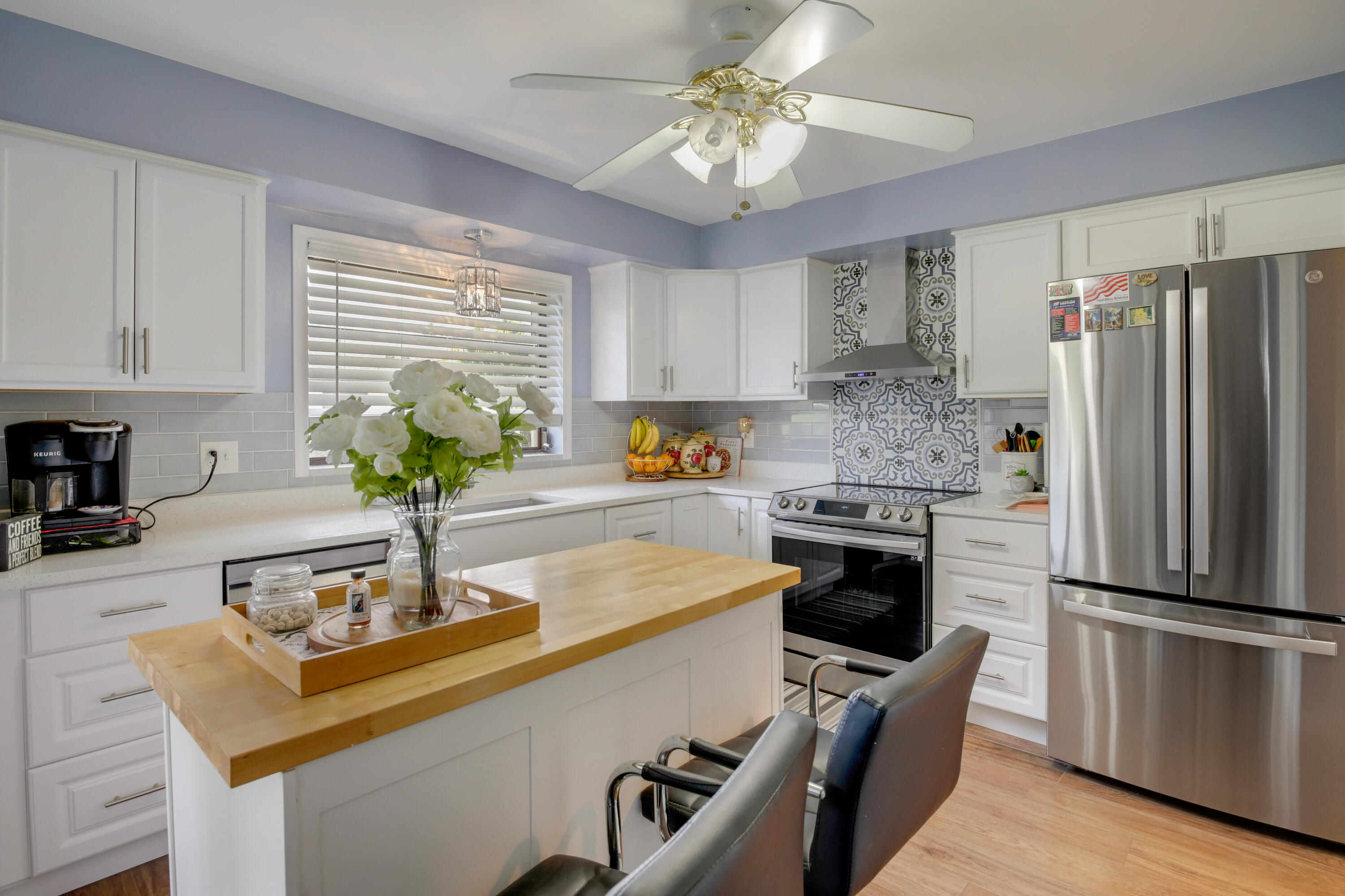 a kitchen with kitchen island a counter and a stove