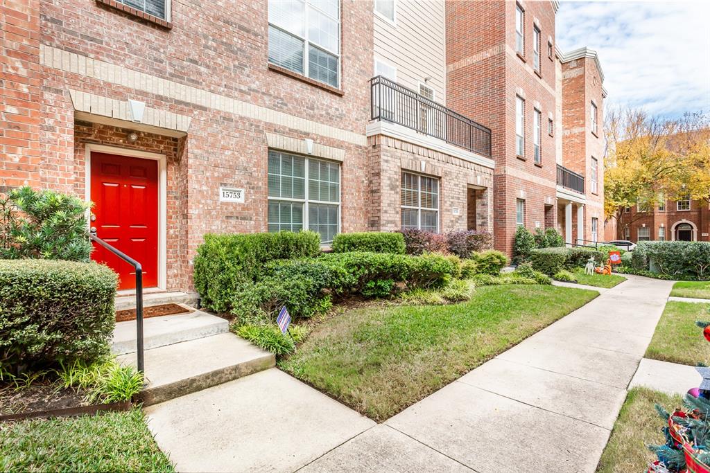 a view of a brick building next to a yard