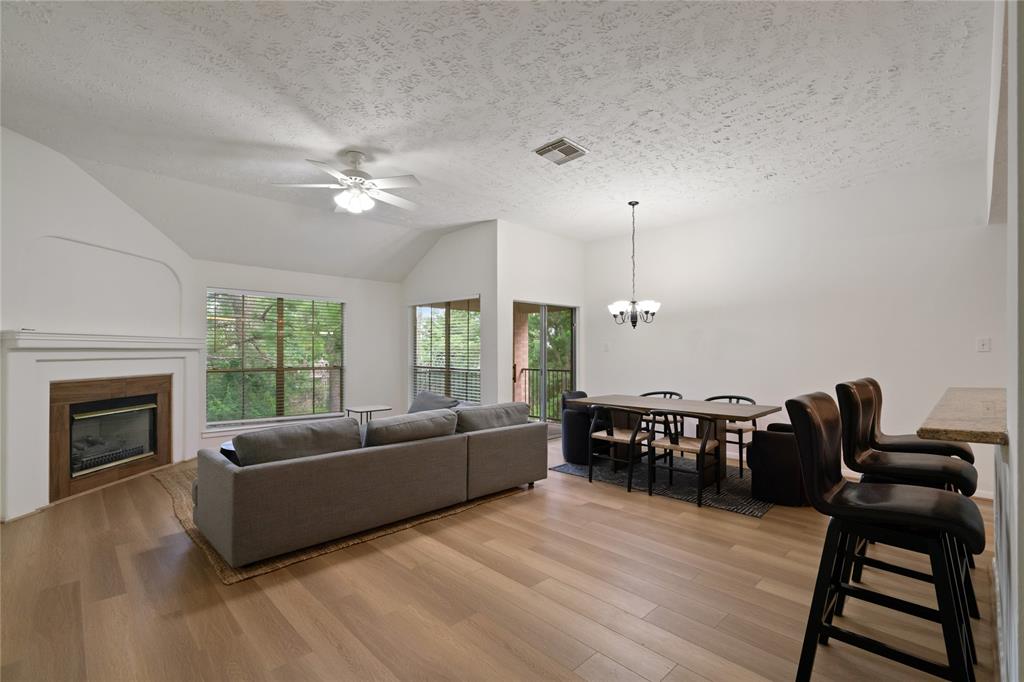 a living room with furniture a fireplace and a window