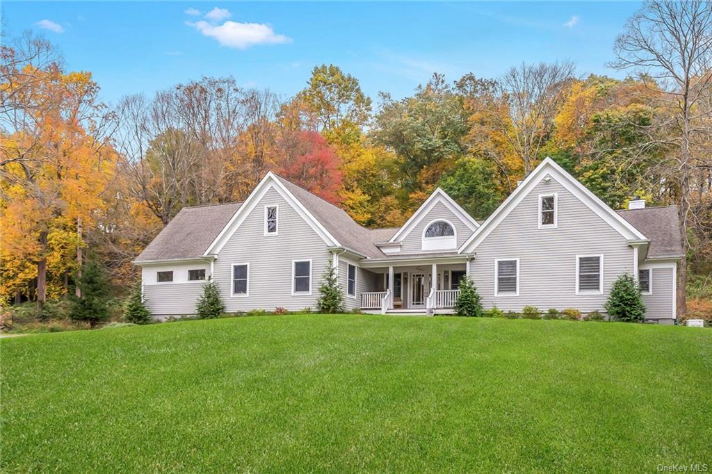 a front view of house with yard and green space