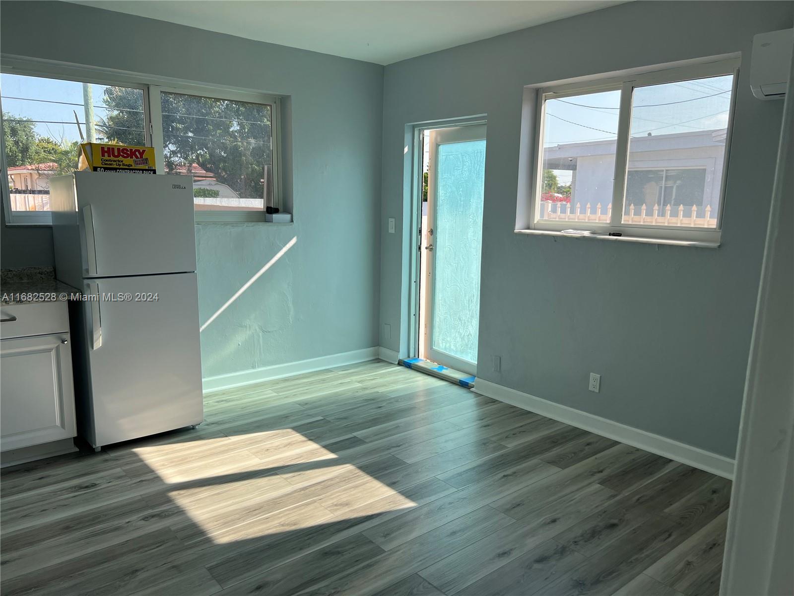 a view of a room with wooden floor and a window