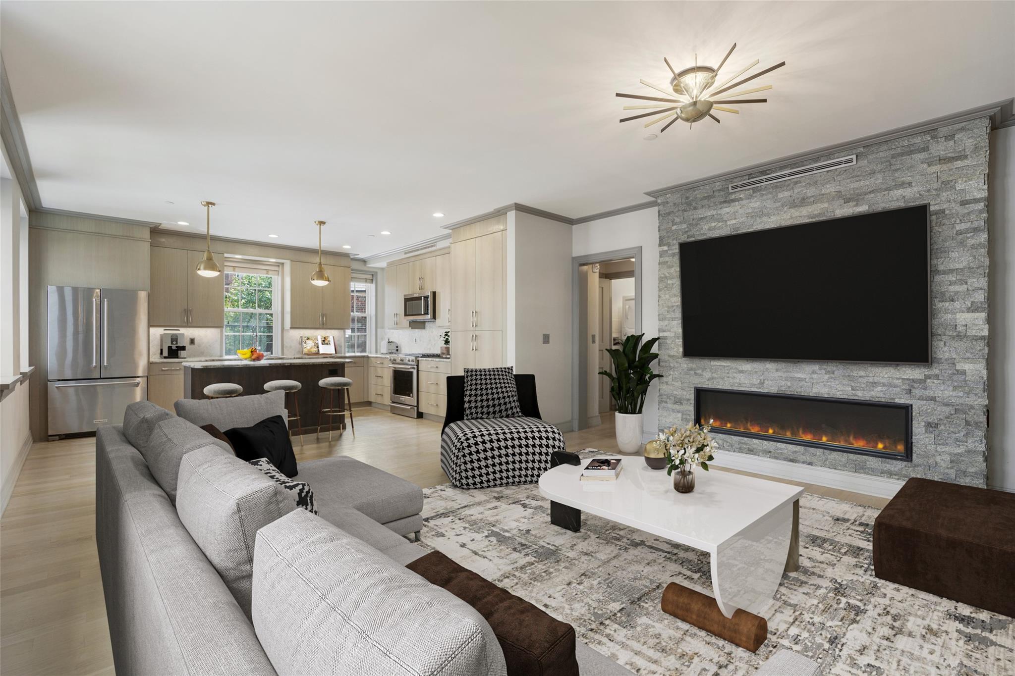 a living room with furniture a flat screen tv and a fireplace