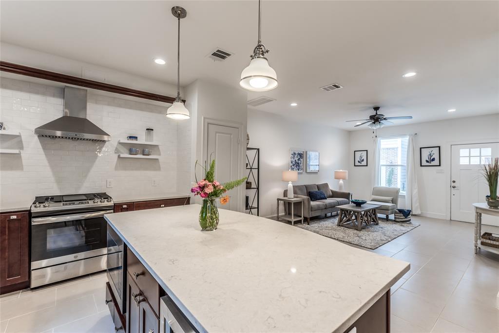 a kitchen with a stove a sink and a refrigerator