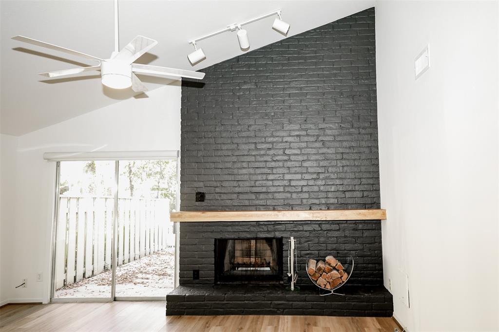 a view of a livingroom with a fireplace and a window