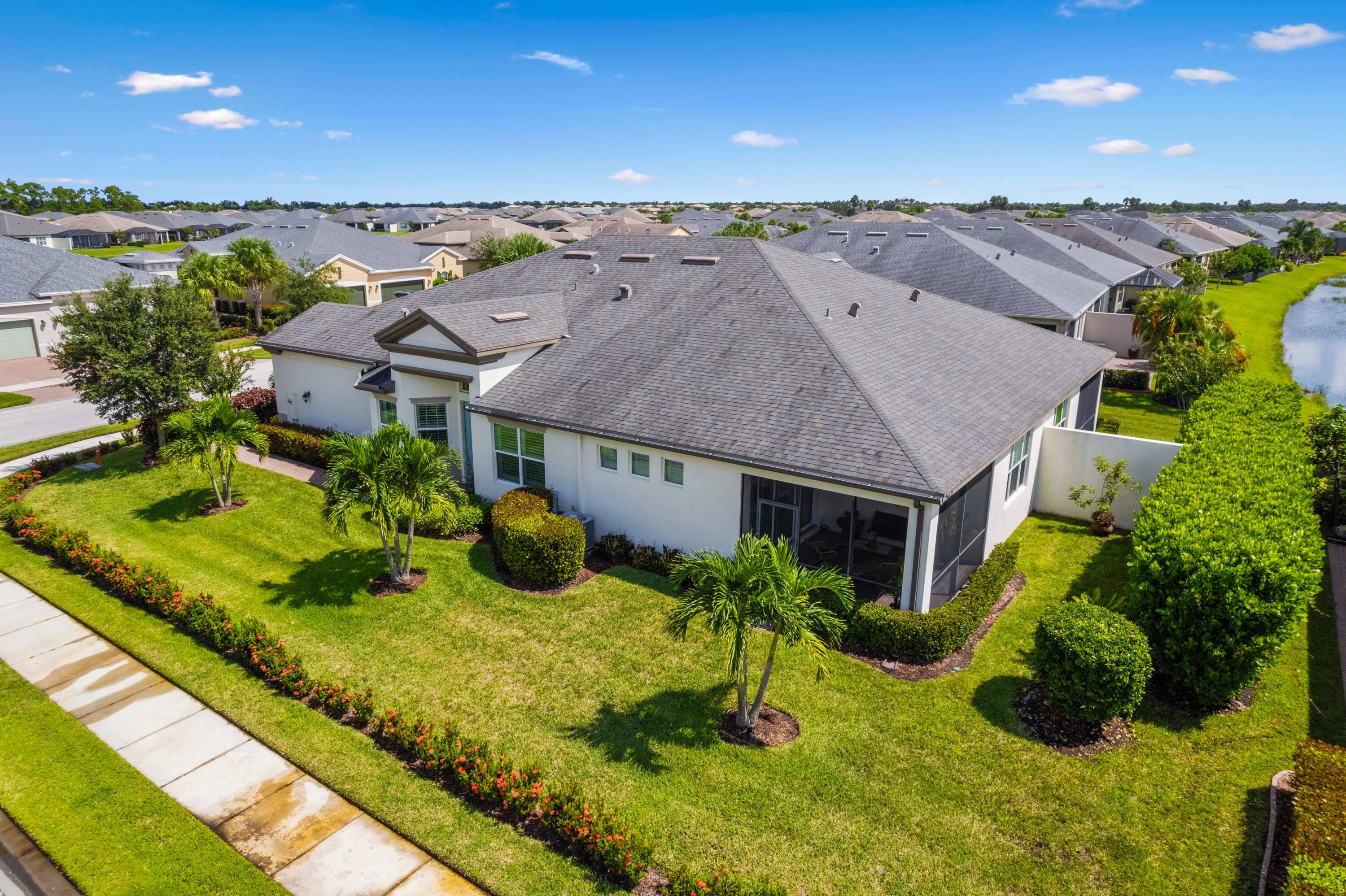 a aerial view of a house with a yard table and chairs