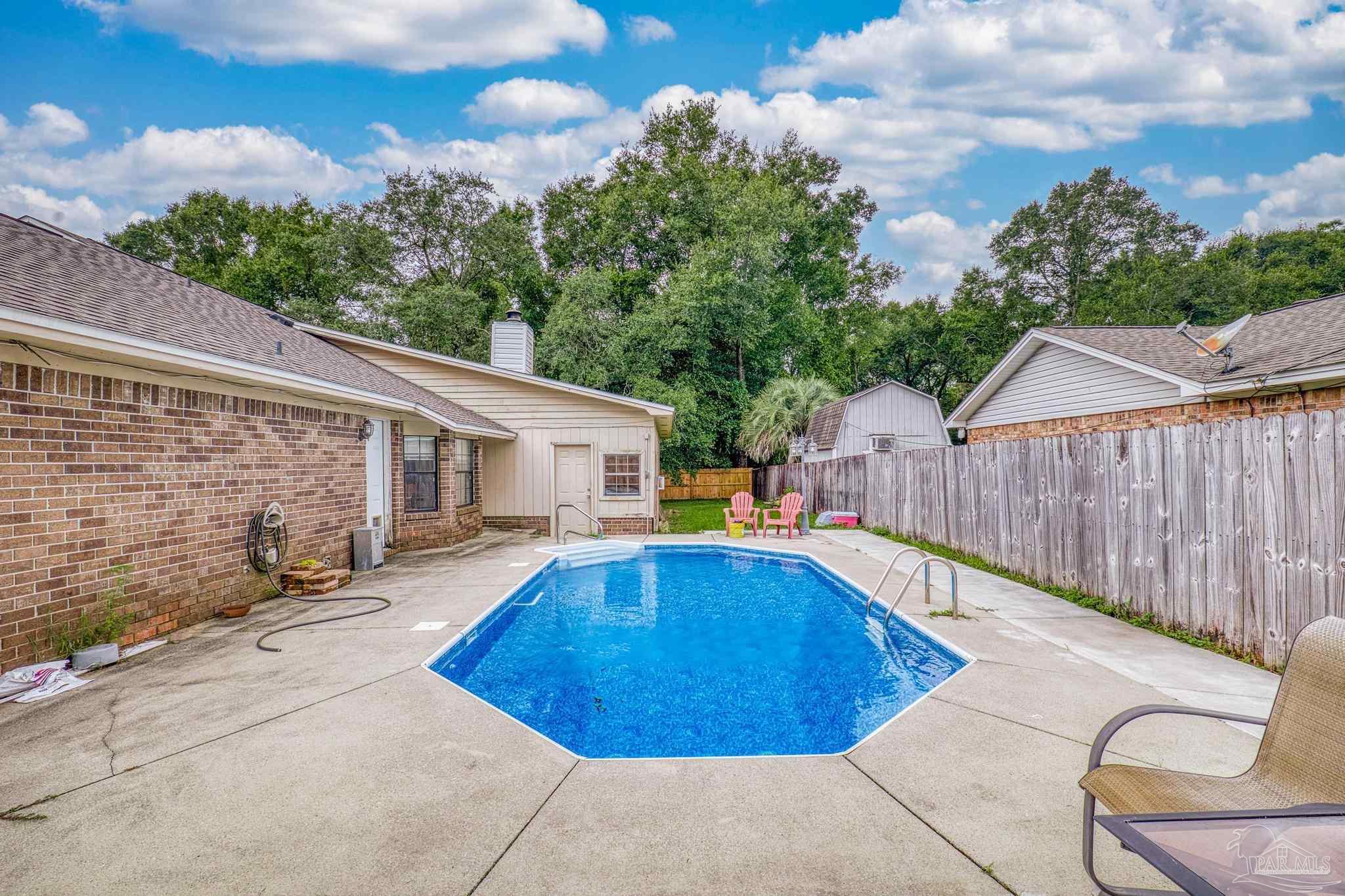 a view of a swimming pool with a patio