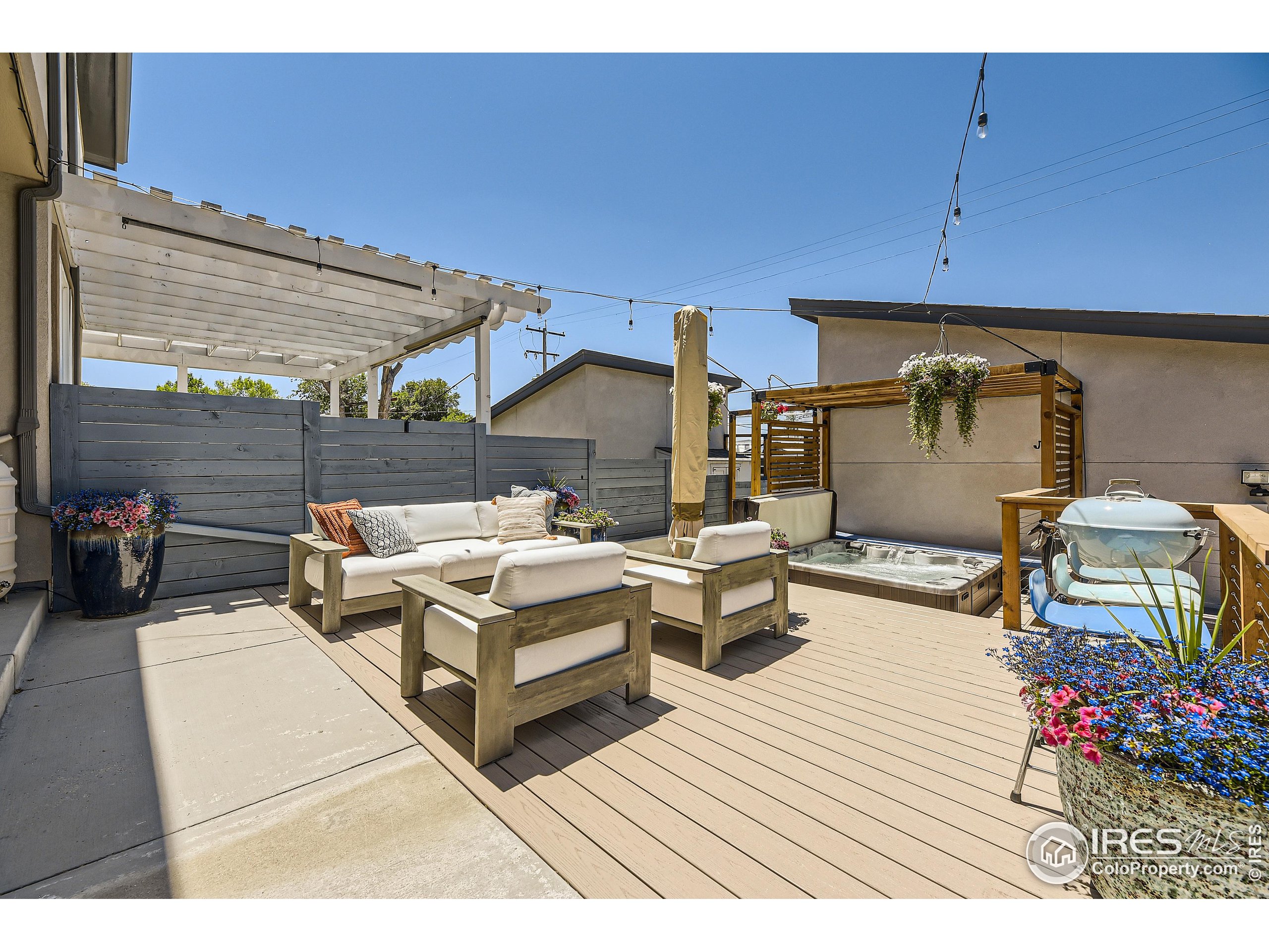 a view of a chairs and table in the back yard of the house