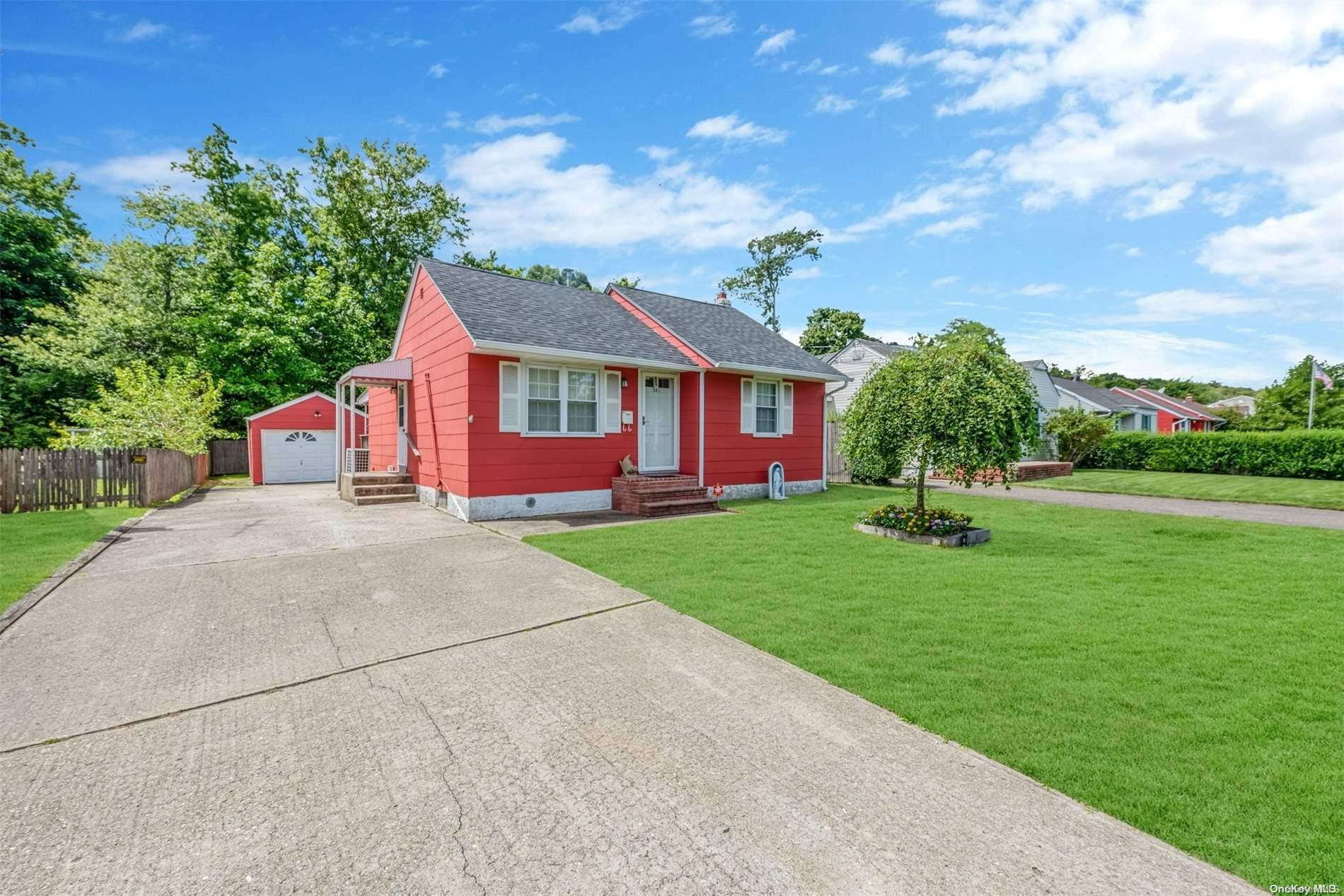 a front view of a house with a garden and yard