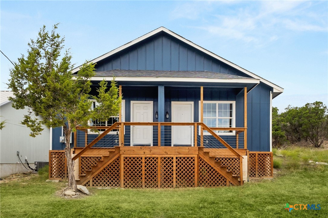 a view of house with backyard and trees