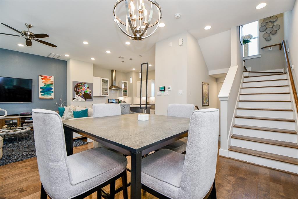 a dining room with furniture and wooden floor