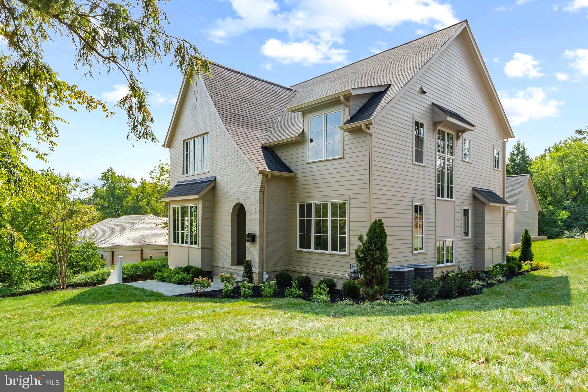 a front view of house with yard and green space