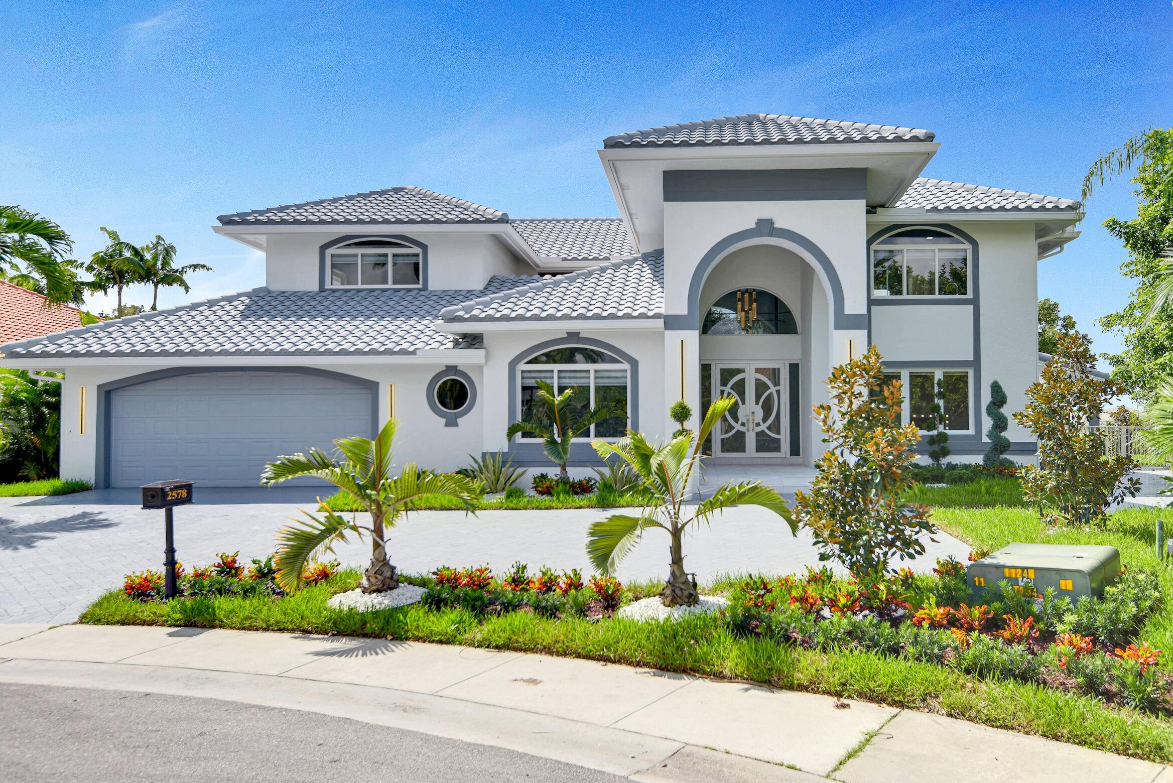 a front view of a house with a garden