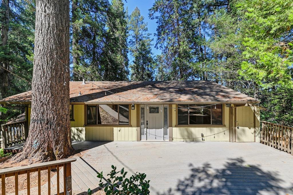 a view of a house with a tree in the background