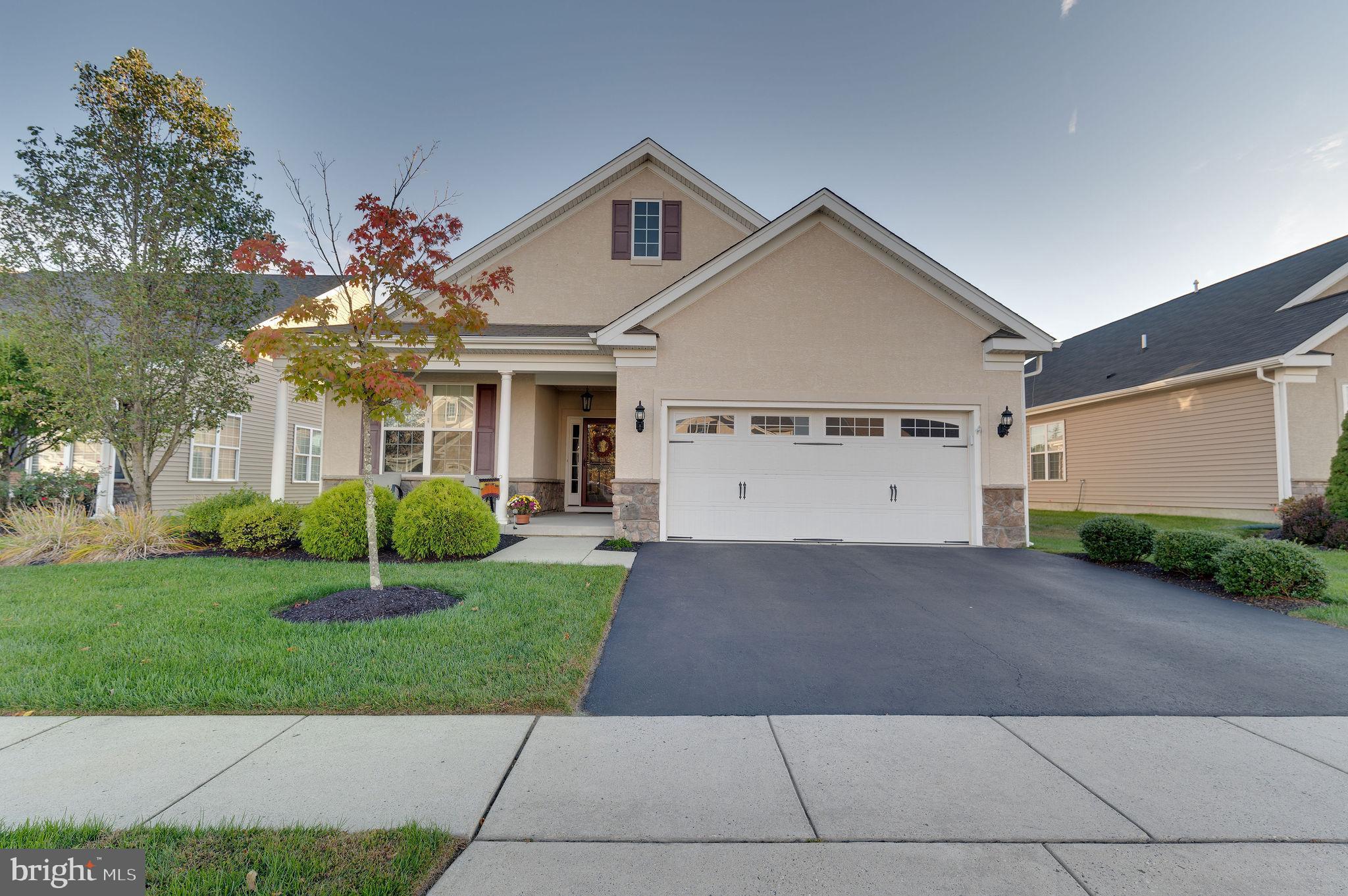 a front view of a house with a yard and a garage