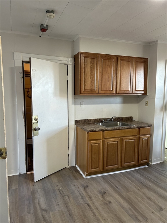 a living room with stainless steel appliances granite countertop a refrigerator and a stove top oven