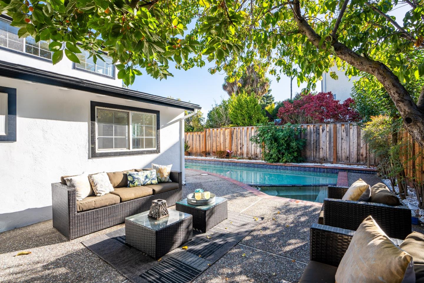 a view of a patio with couches chairs and a fire pit