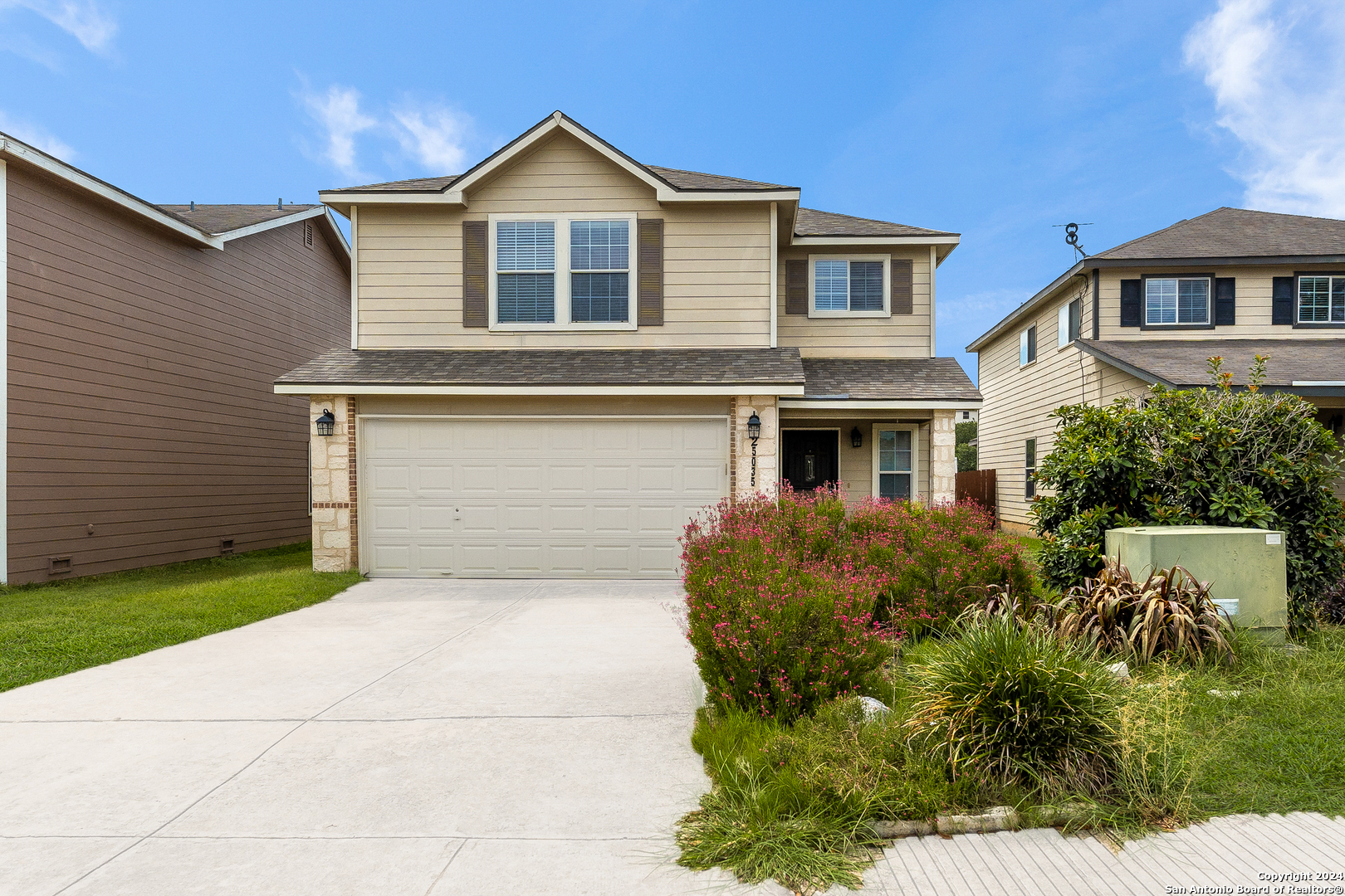 a front view of a house with a yard and garage