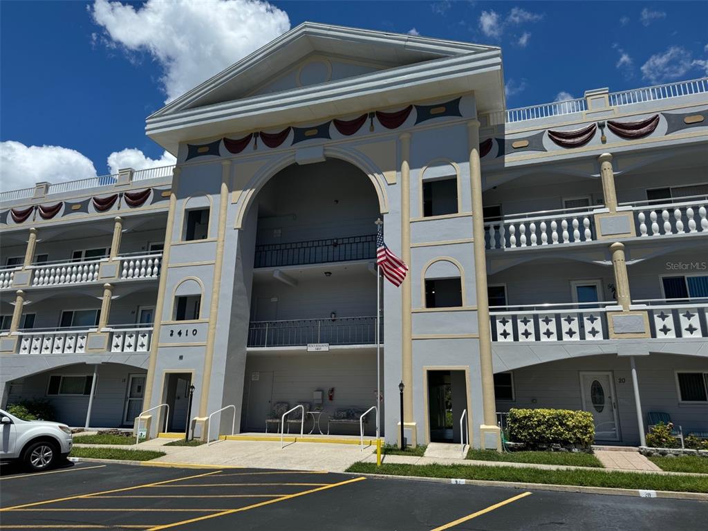 a front view of a building with parking space and parking