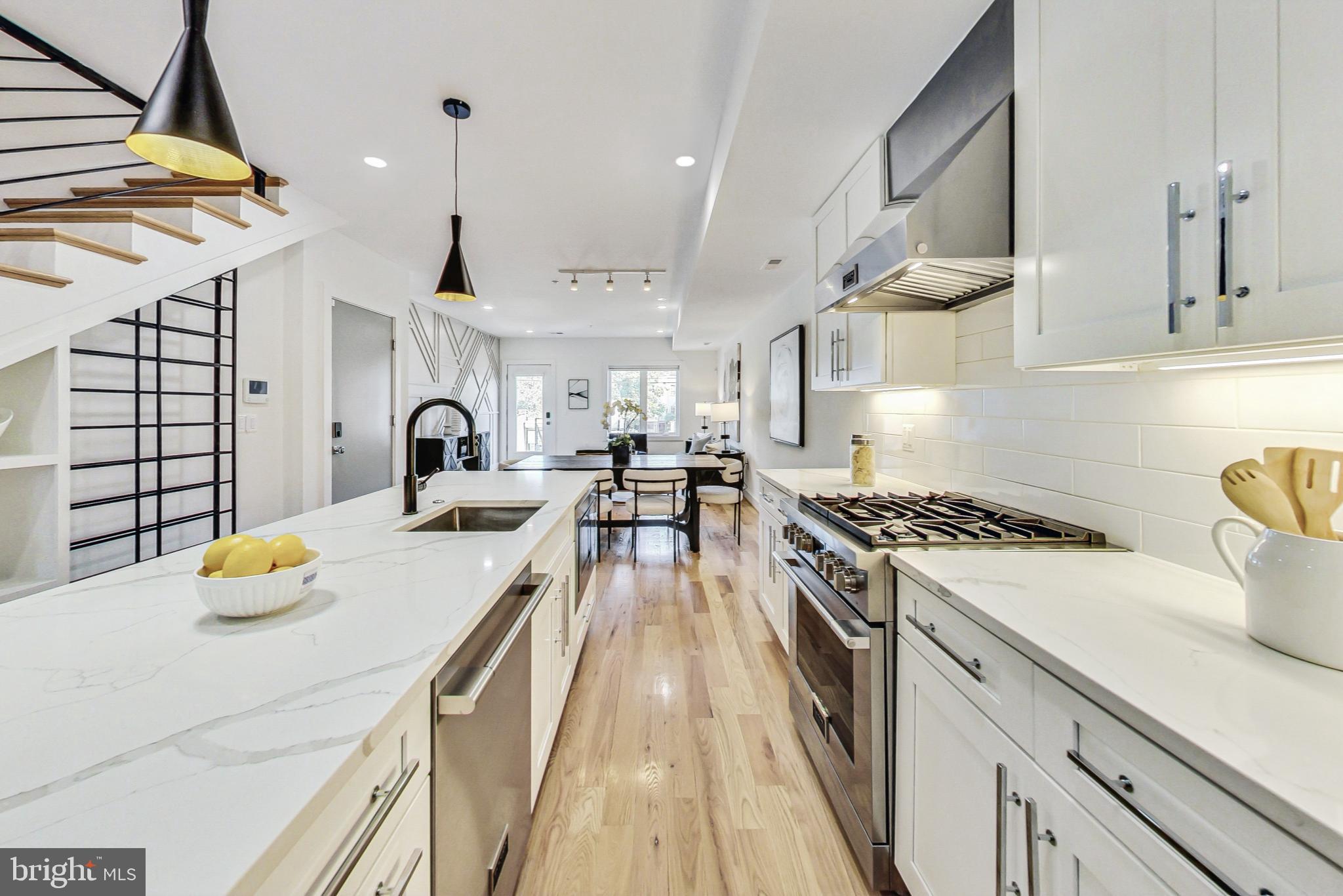 a kitchen with a stove a sink and a refrigerator