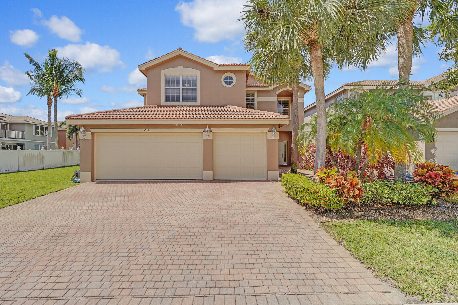 a front view of a house with a yard and a garage