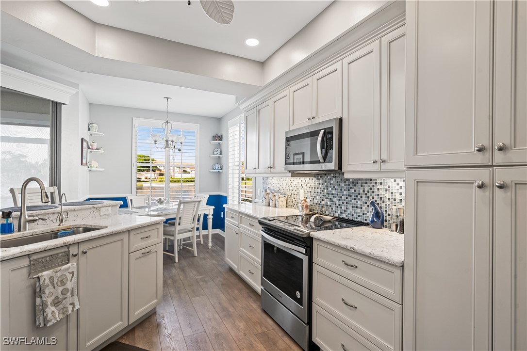 a kitchen with a sink stove and cabinets