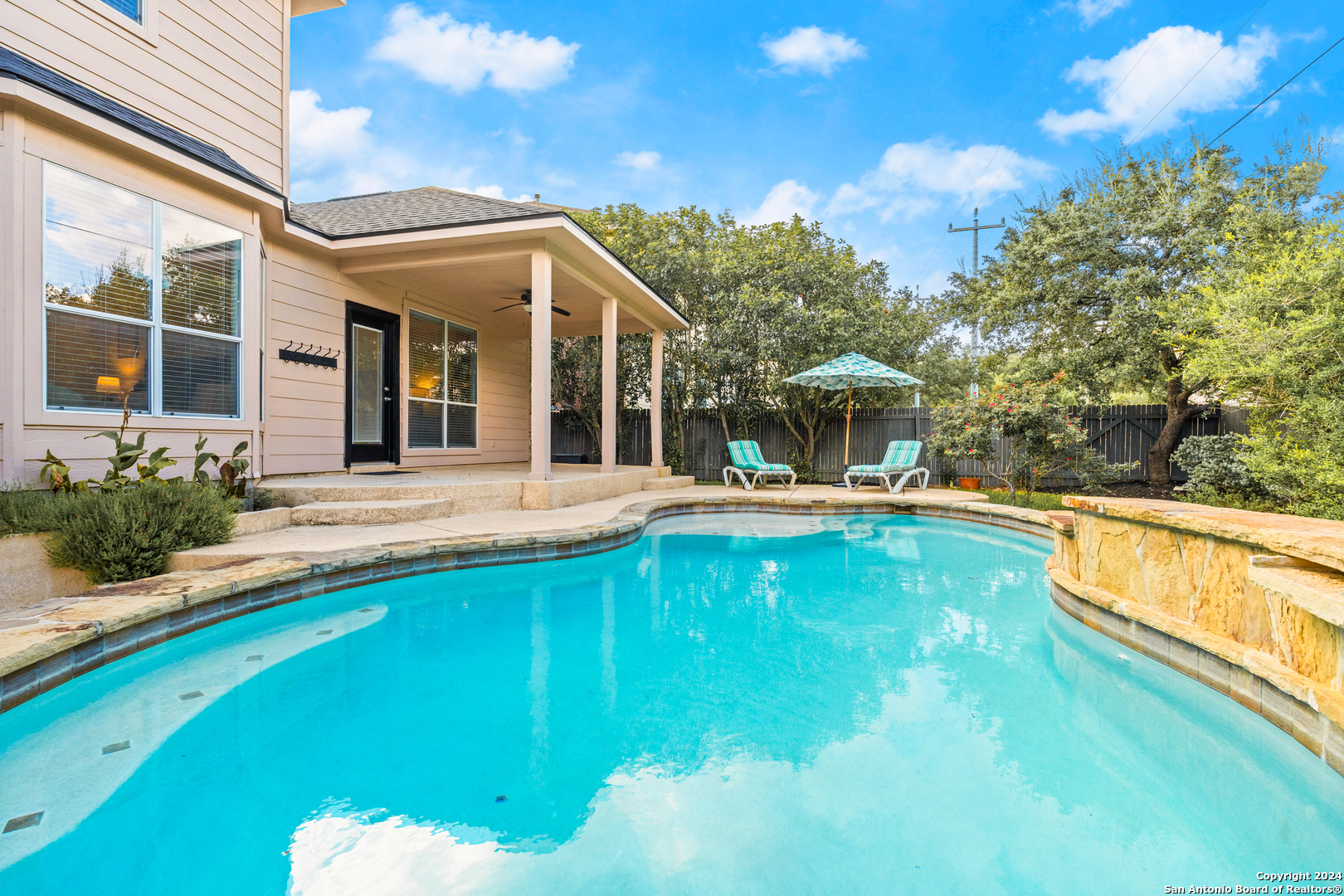 a view of a house with swimming pool and porch