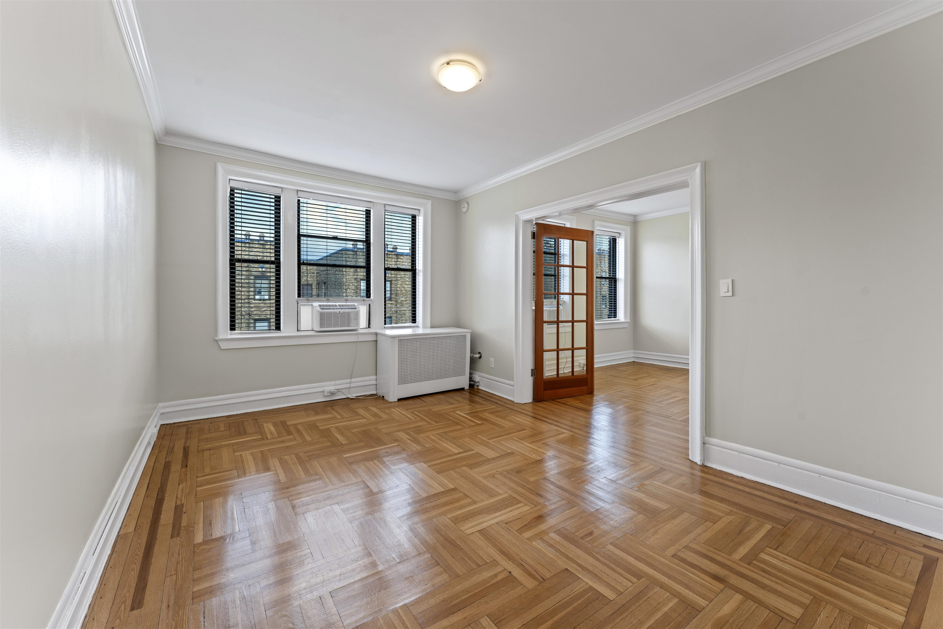 wooden floor in an empty room with a window