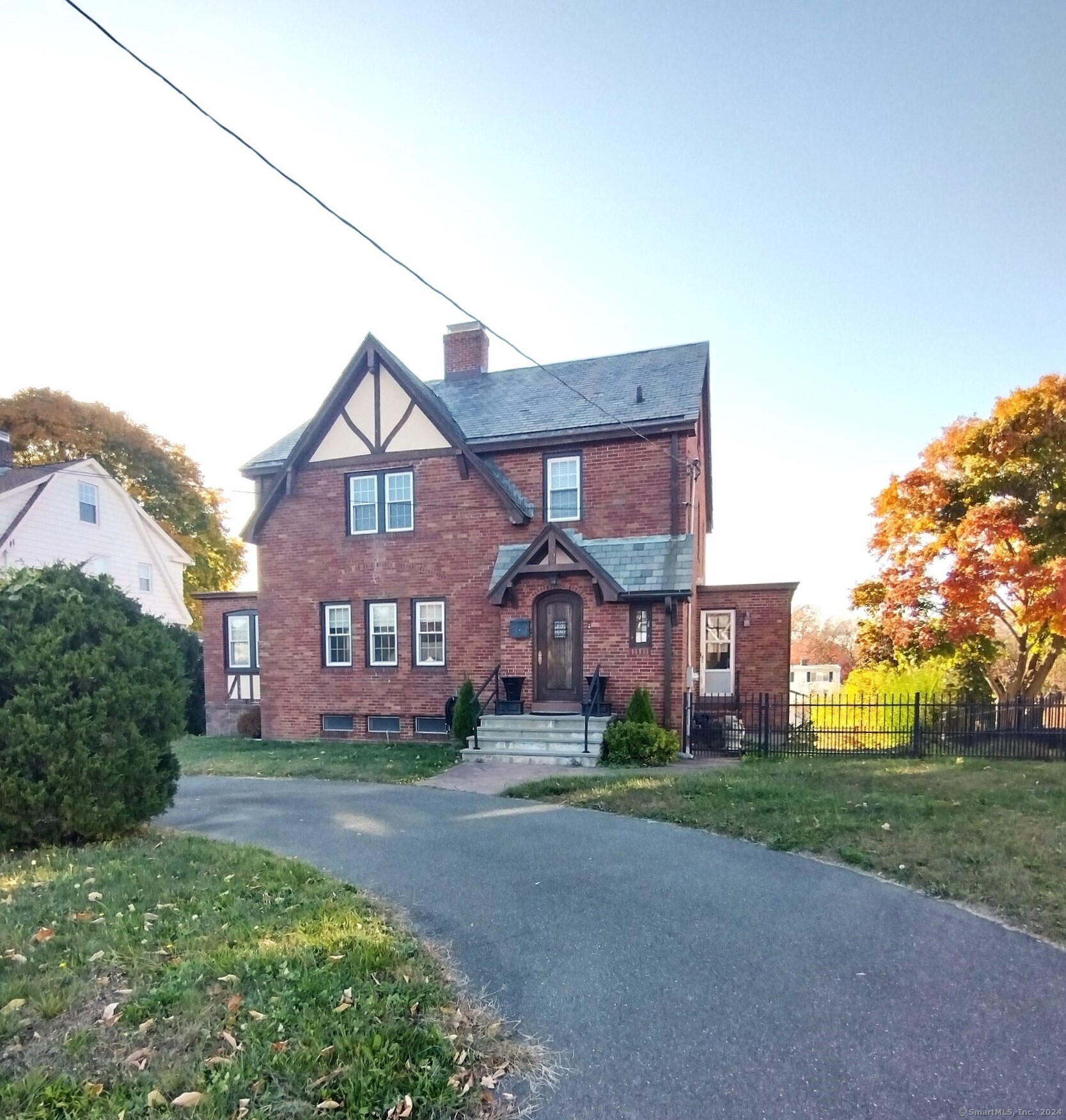 front view of a brick house with a yard