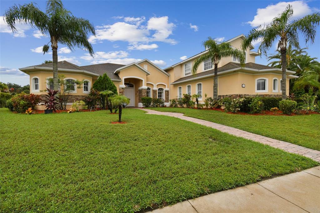 a front view of house with yard and green space