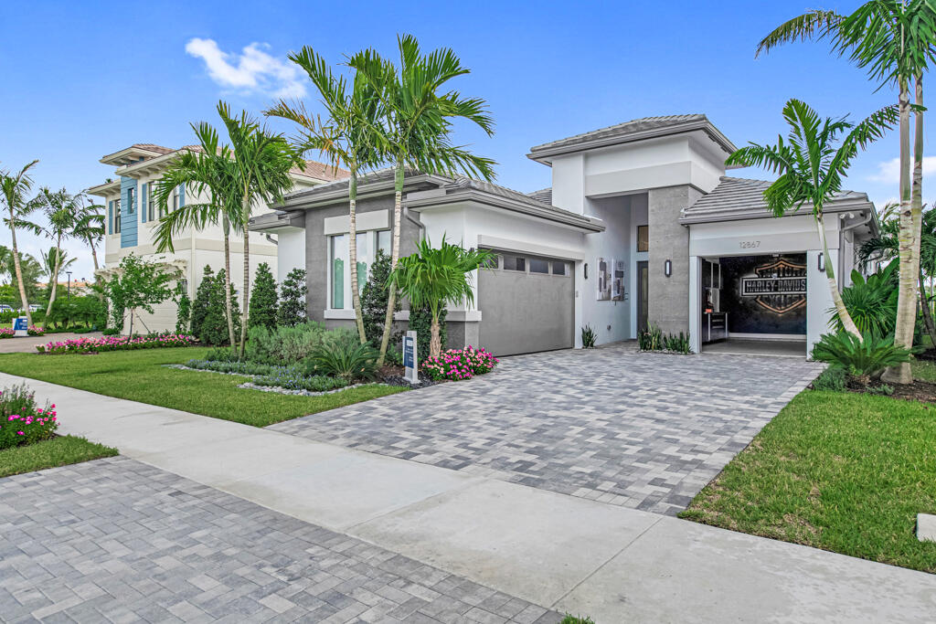 a view of a house with a yard and palm trees