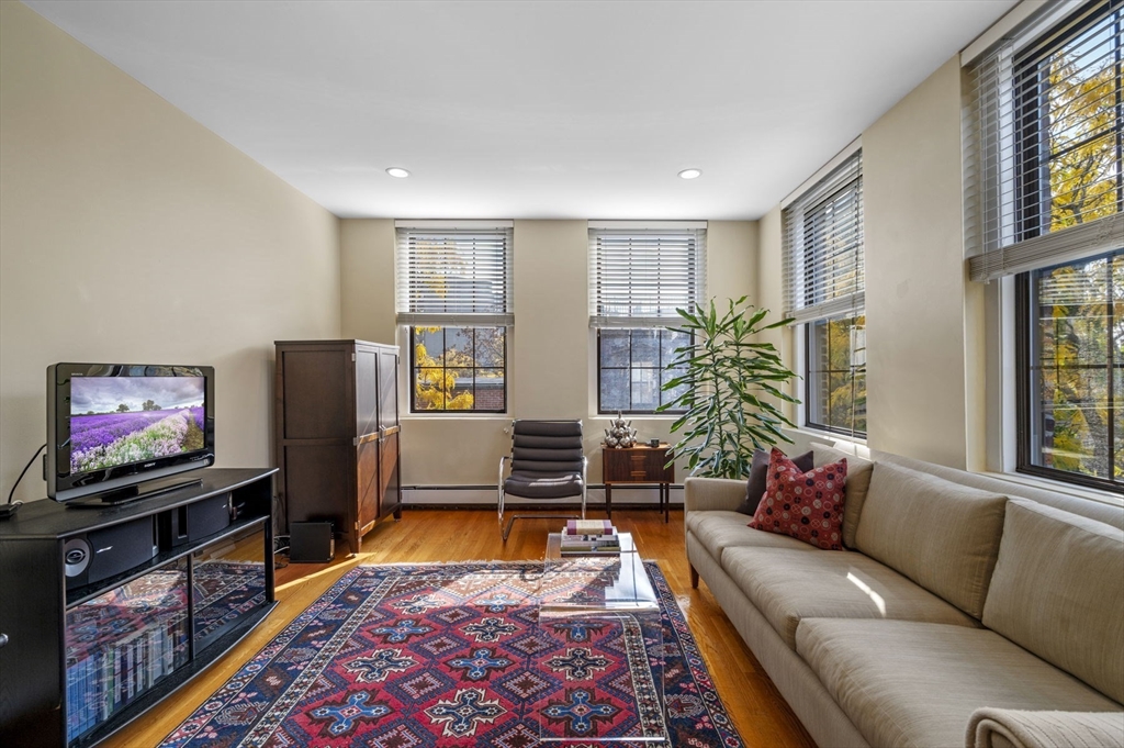 a living room with furniture flat screen tv and a window