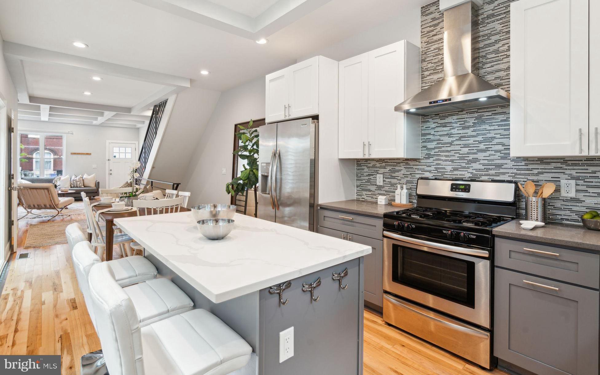 a kitchen with a stove a sink and a refrigerator