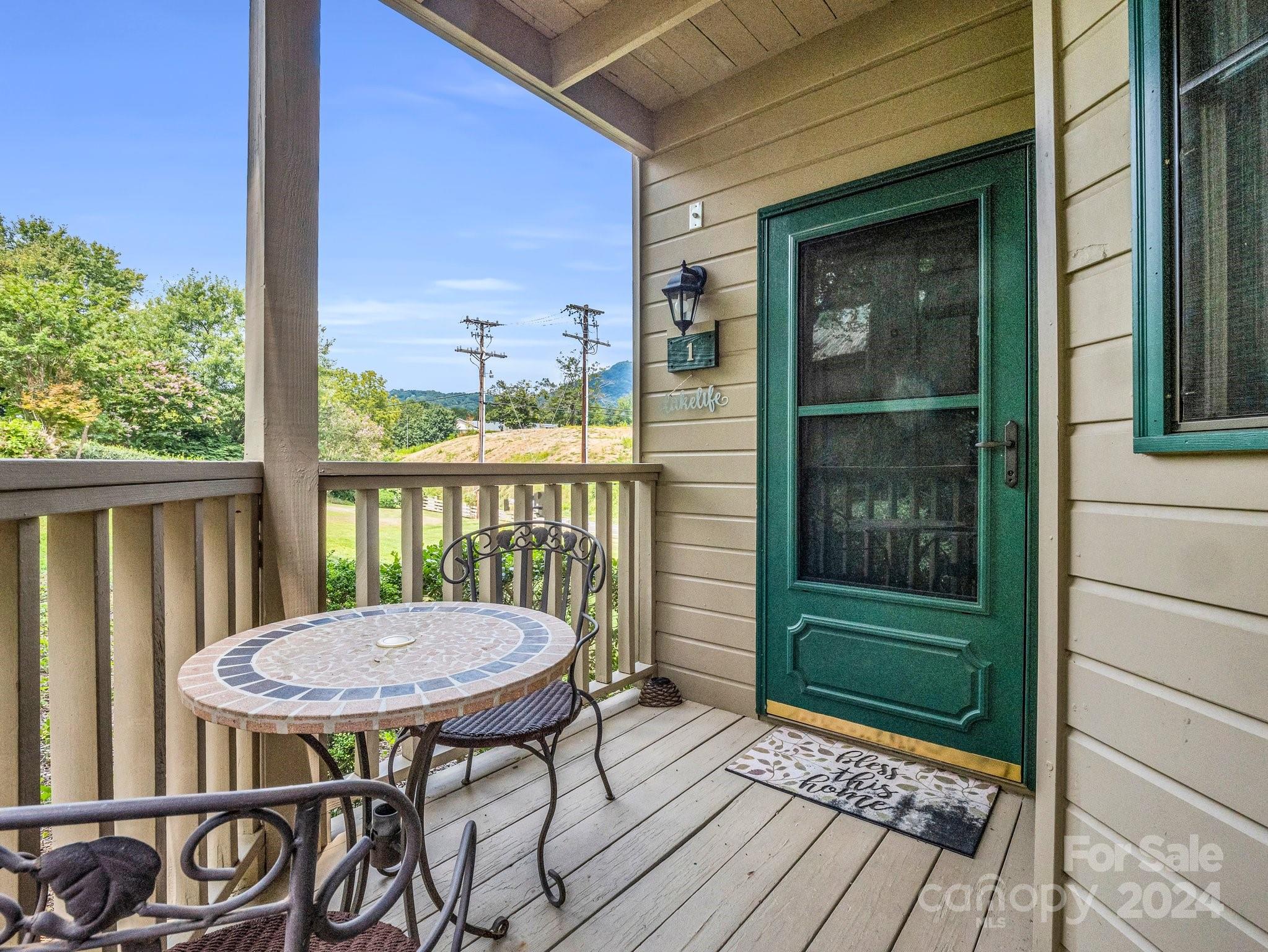 a view of a balcony with table and chairs