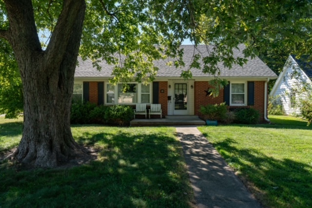 a front view of house with yard and green space