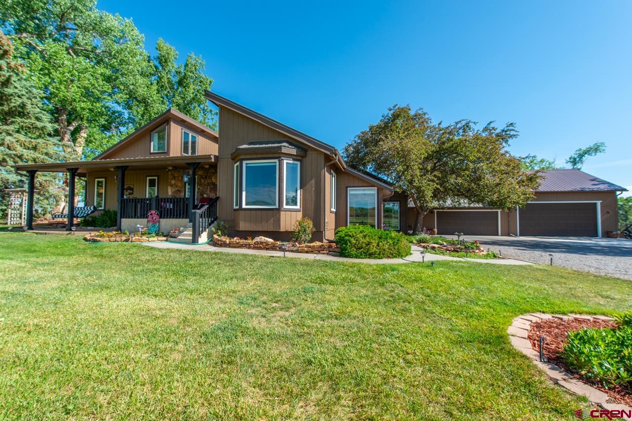 a front view of house with yard and green space