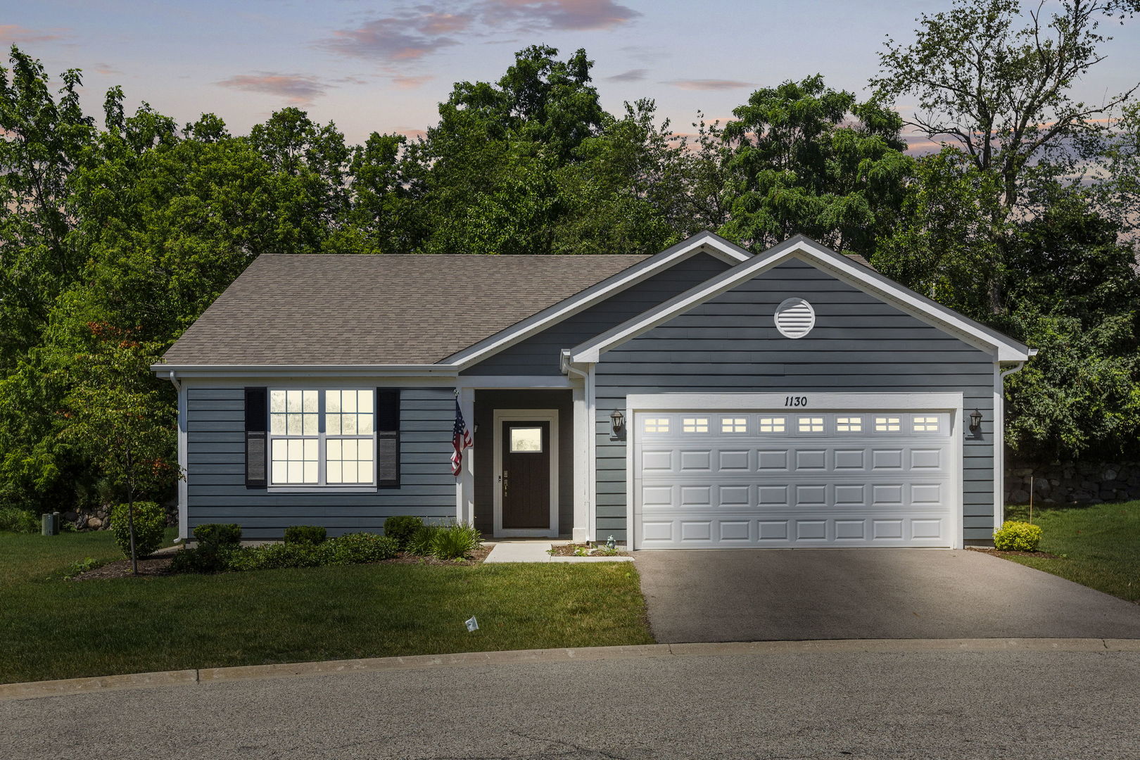 a front view of a house with a yard and garage