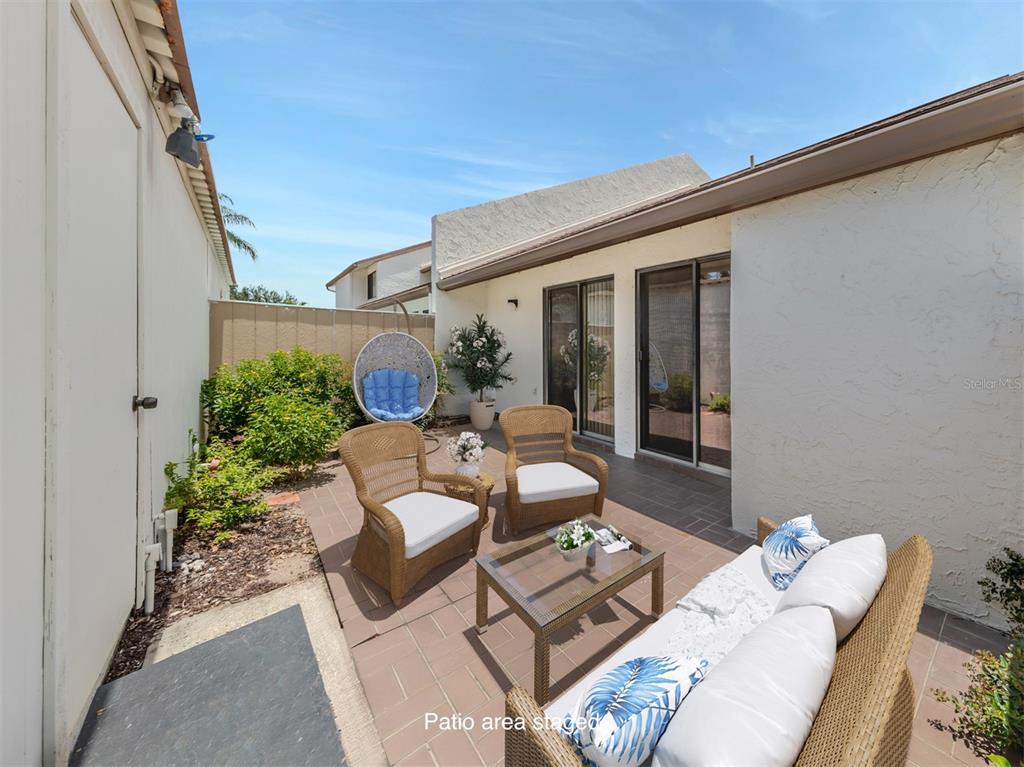 a view of a patio in the backyard