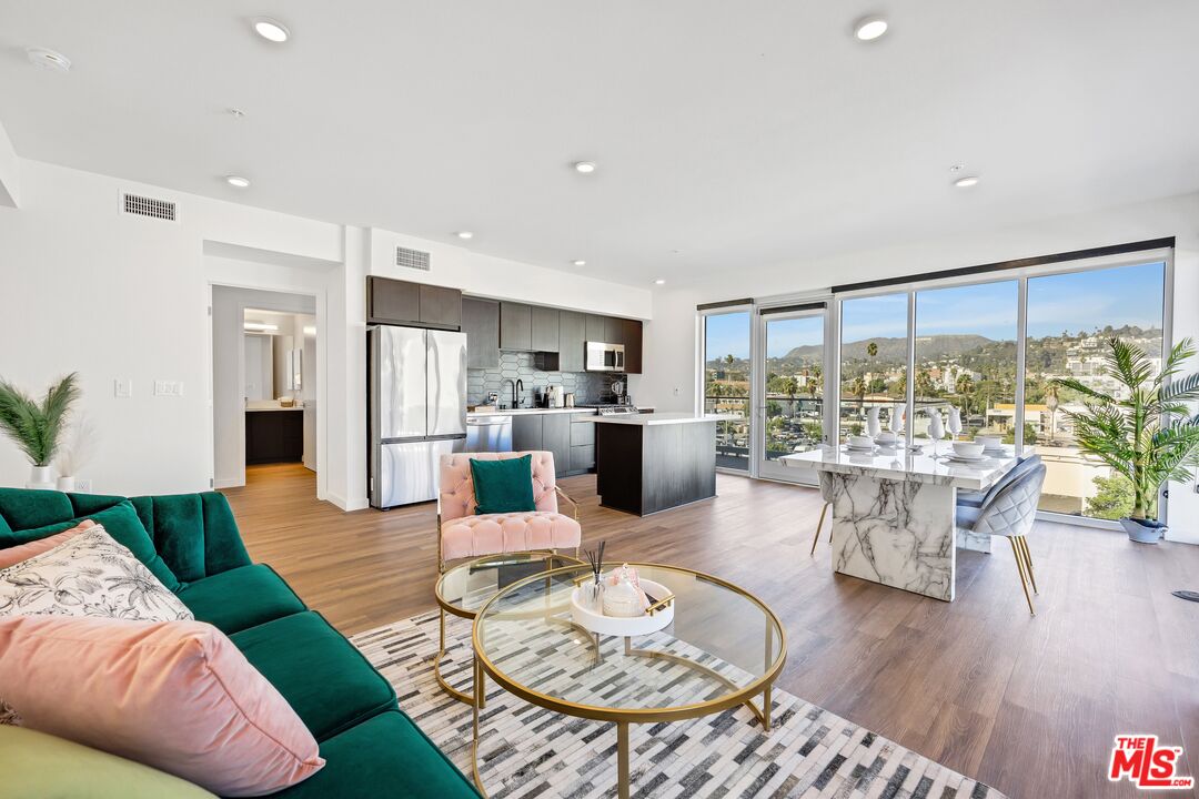 a living room with furniture dining table and wooden floor