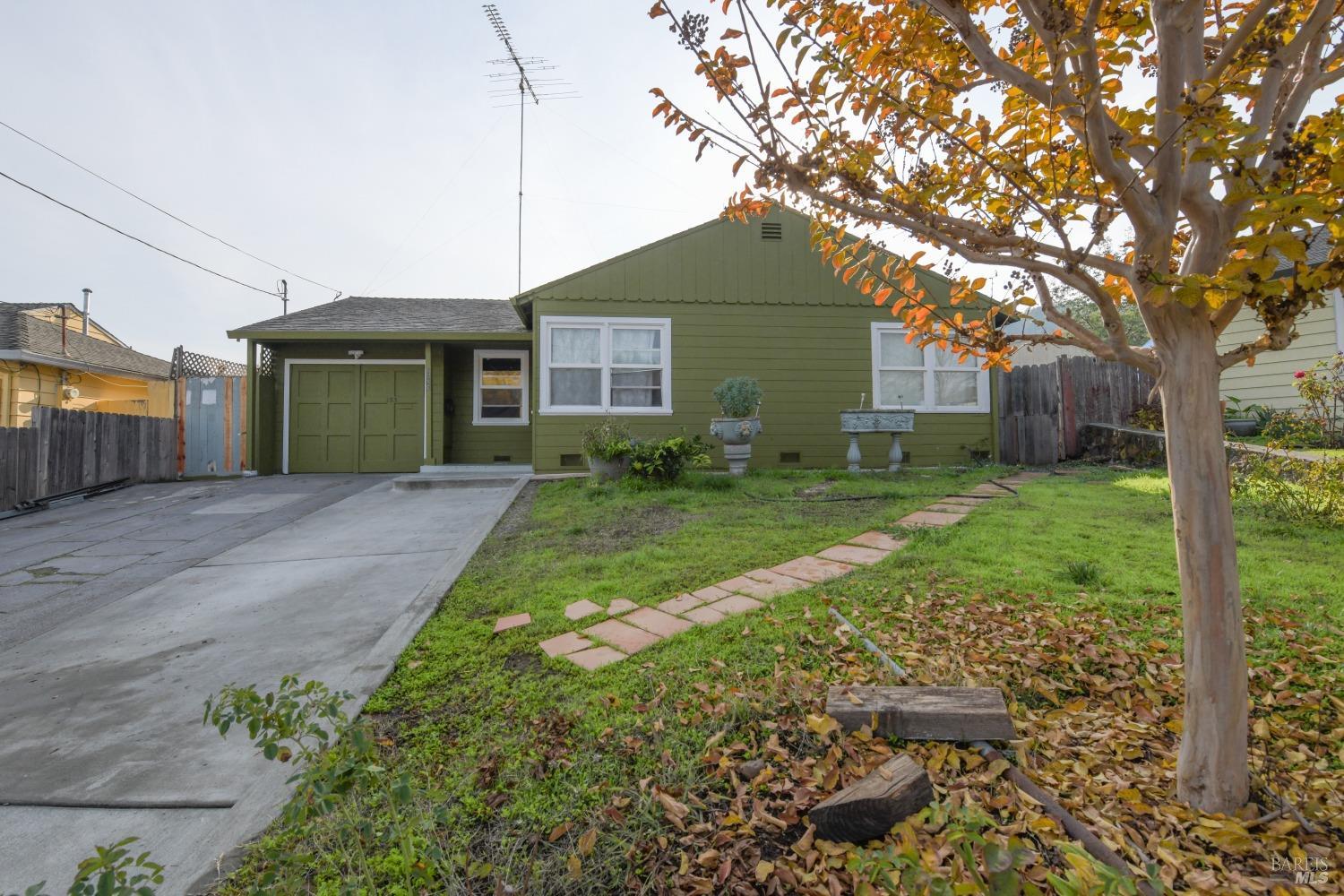 a front view of a house with yard and green space