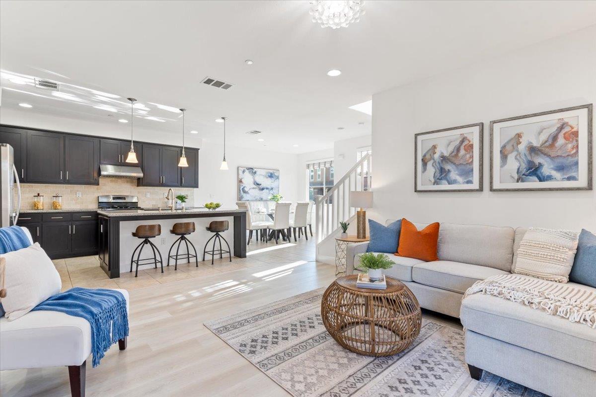 a living room with furniture and kitchen view