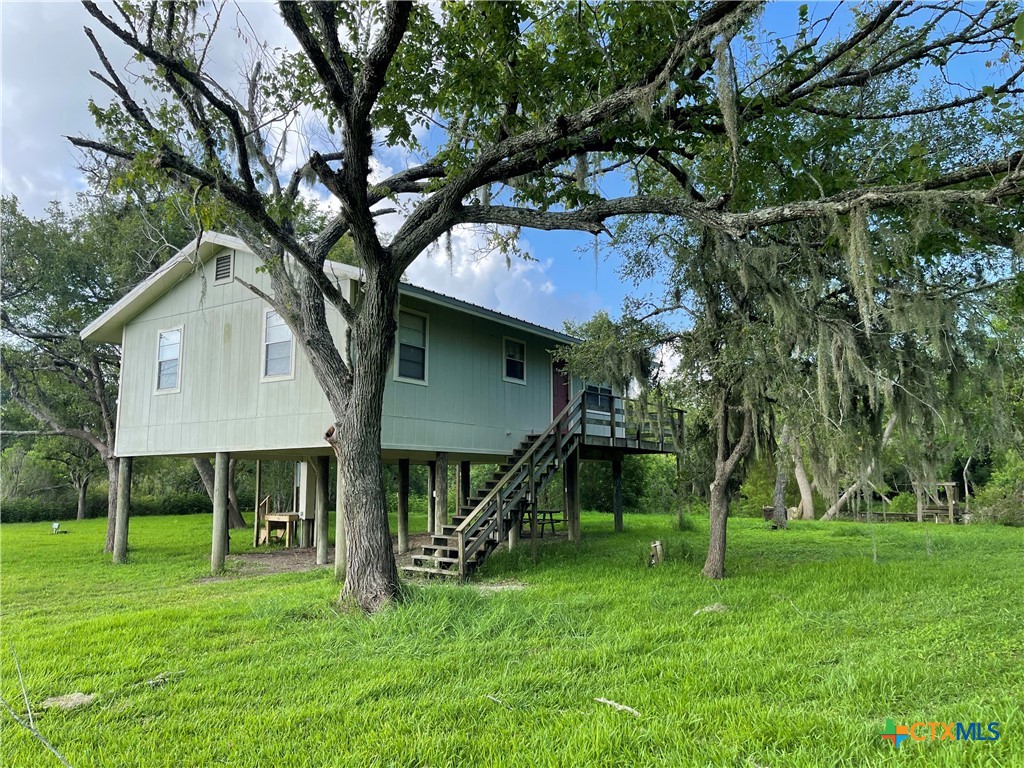 a view of house with a backyard