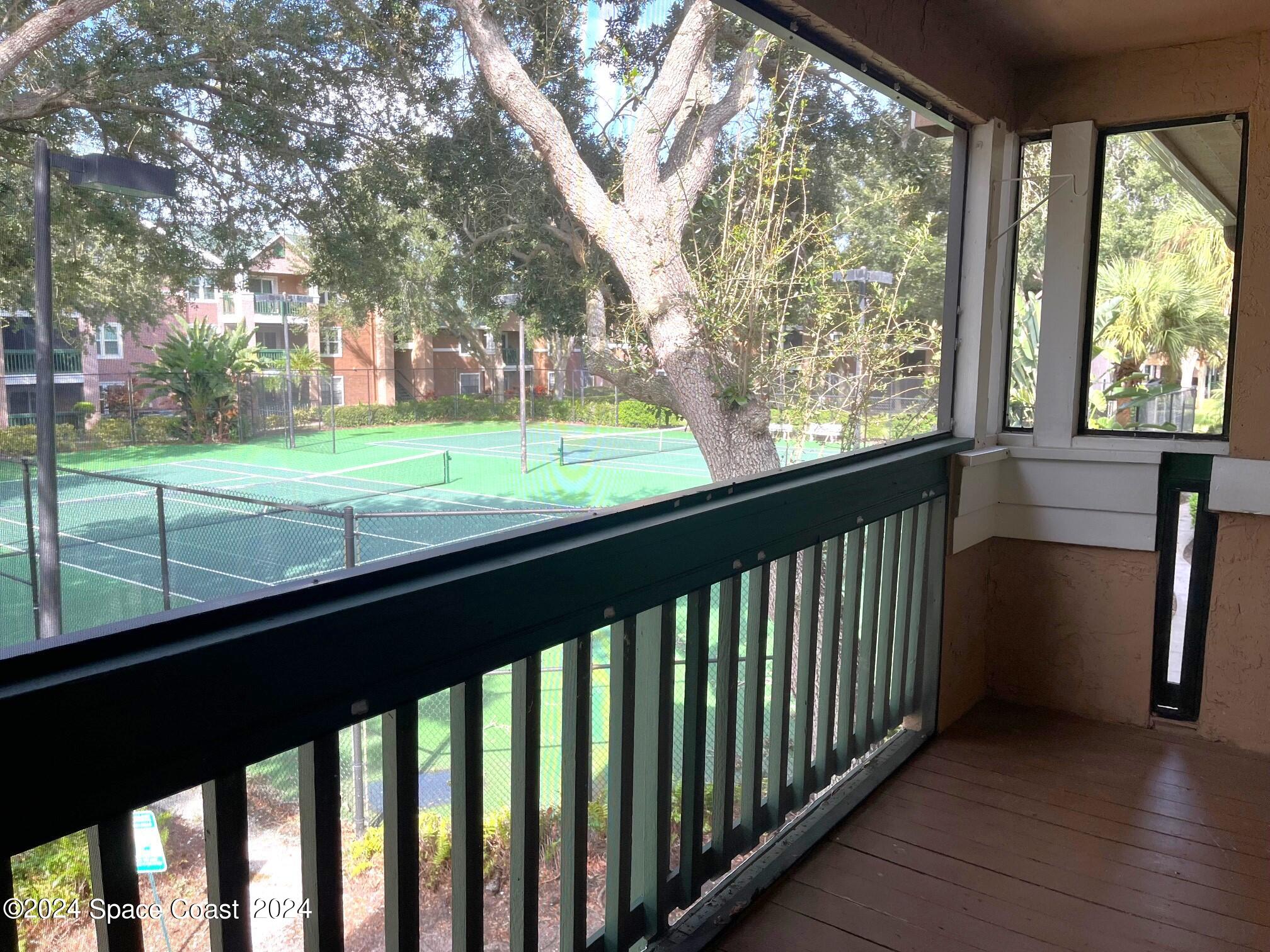 a view of a porch and a yard with wooden fence