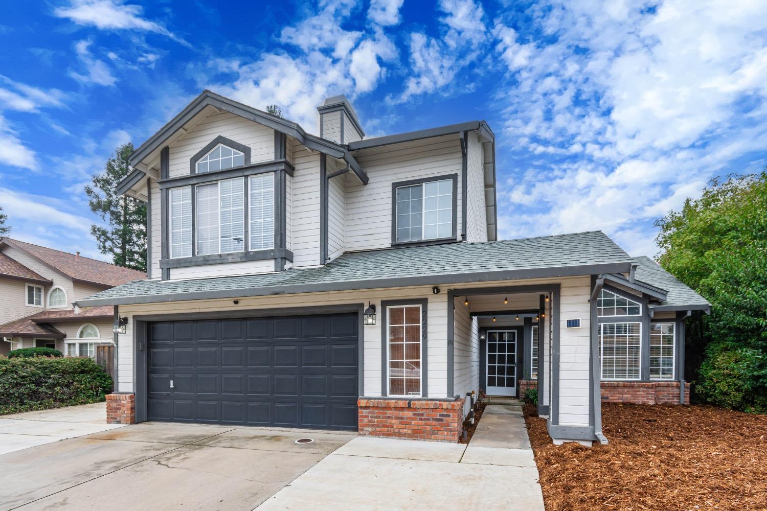 a front view of a house with a garage