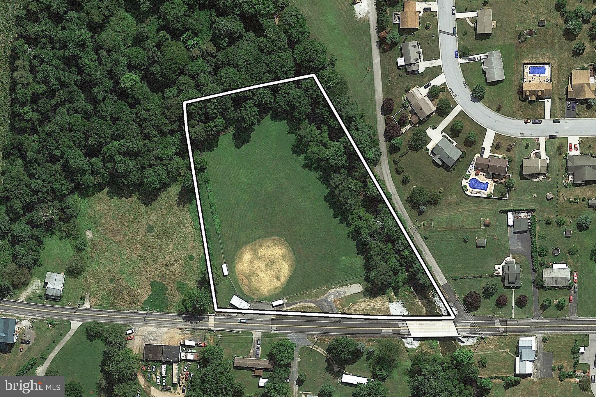 an aerial view of a residential houses with outdoor space