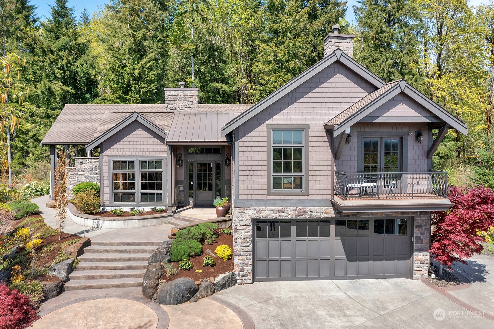 a front view of a house with a yard outdoor seating and mountain view