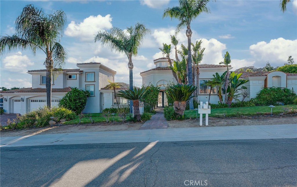 a front view of multiple houses with yard