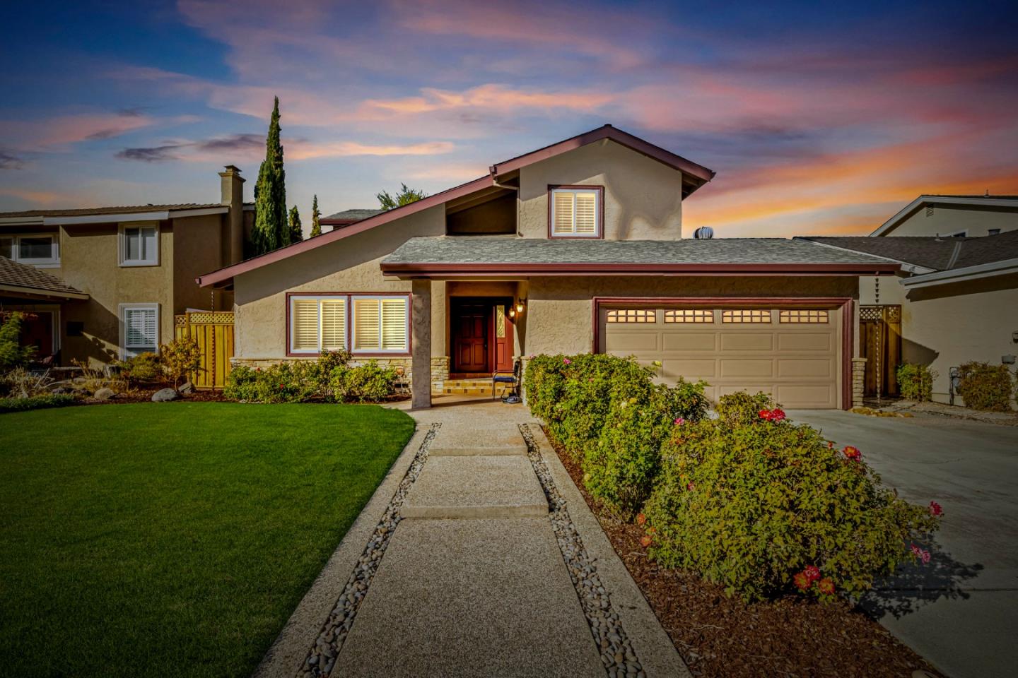 a front view of a house with a garden